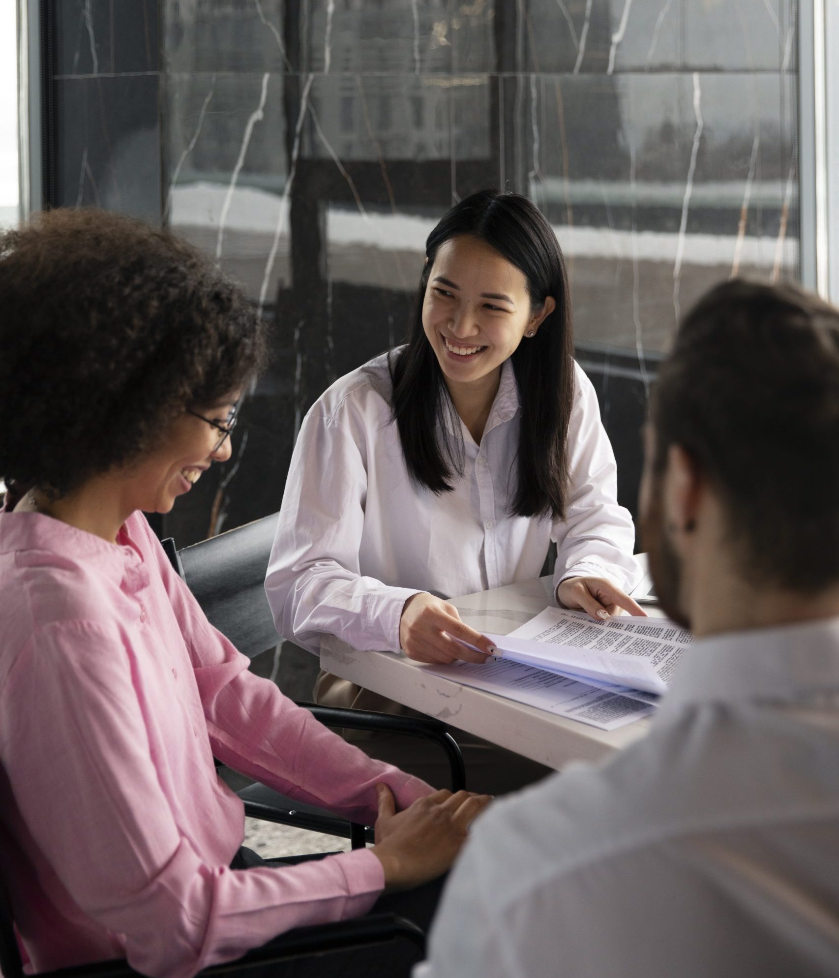 colleagues-working-together-using-documents-debating